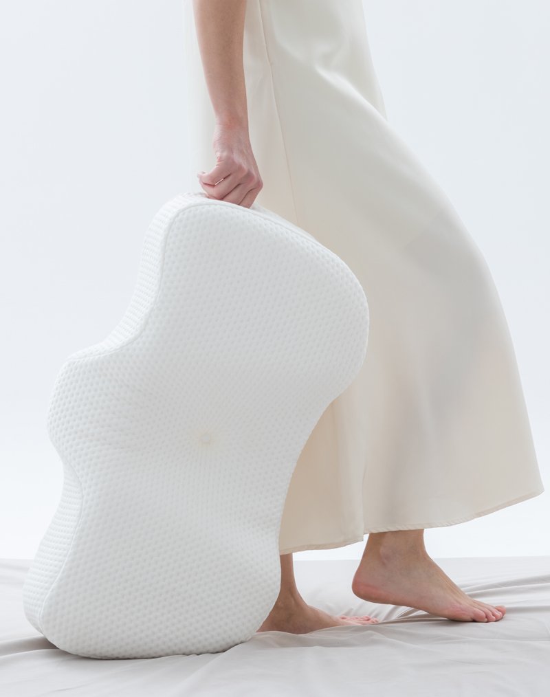 Woman with a pillow on the bed